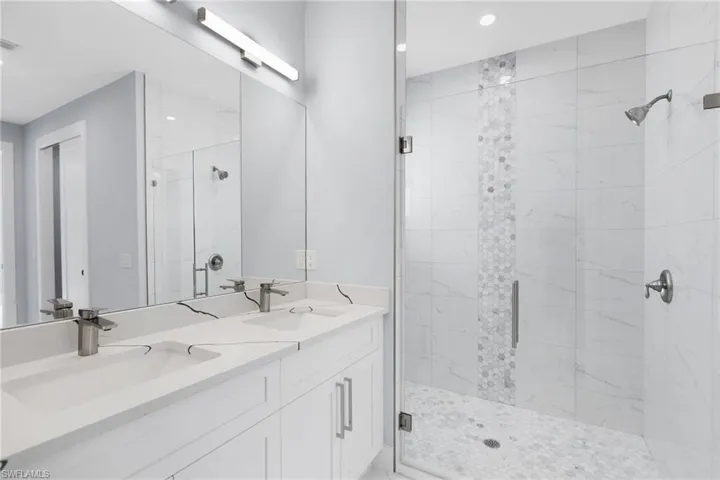 Bathroom with walk in shower and vanity