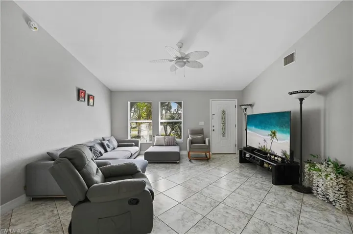 Living room with a ceiling fan and baseboards
