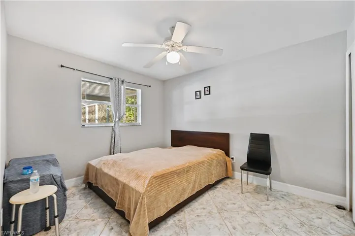 Bedroom with ceiling fan and baseboards