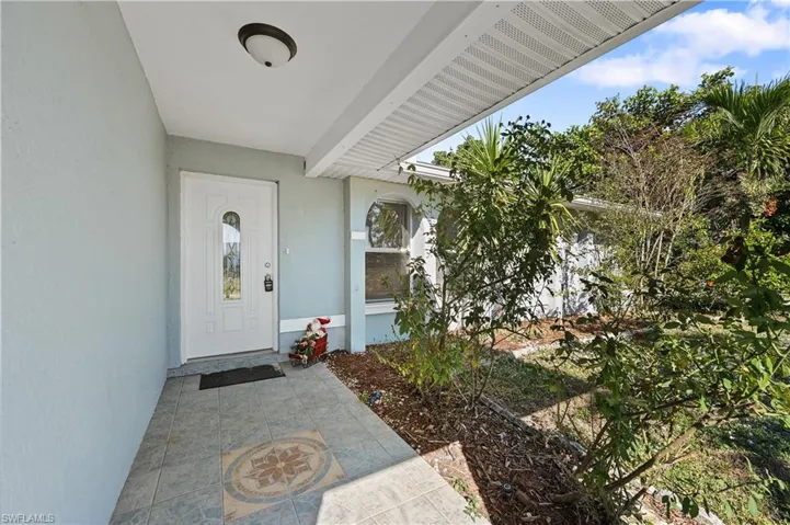 Property entrance featuring stucco siding