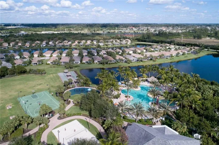 Aerial perspective of resort style area featuring a pool area and a nearby body of water