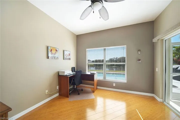 Office featuring a ceiling fan, light wood-type flooring, and healthy amount of natural light