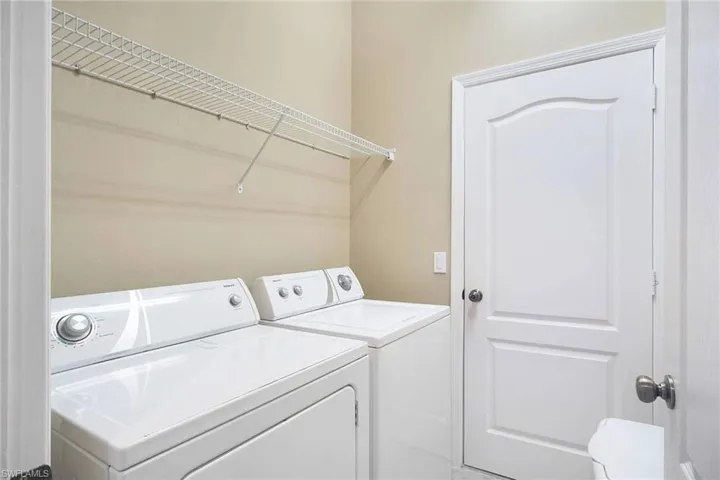 Laundry room with washing machine and clothes dryer