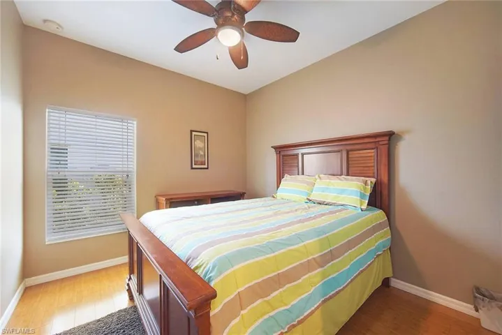 Bedroom with hardwood / wood-style floors and ceiling fan