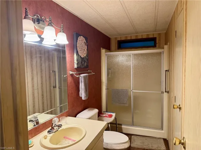 Bathroom featuring vanity and shower / bath combination with glass door