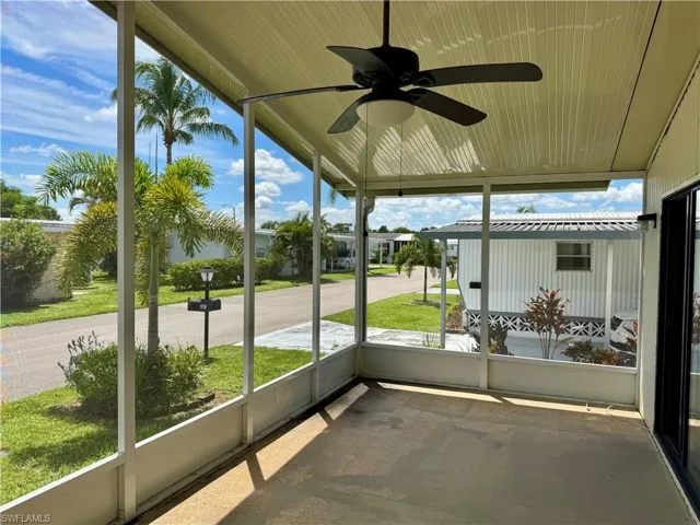 Unfurnished sunroom featuring ceiling fan