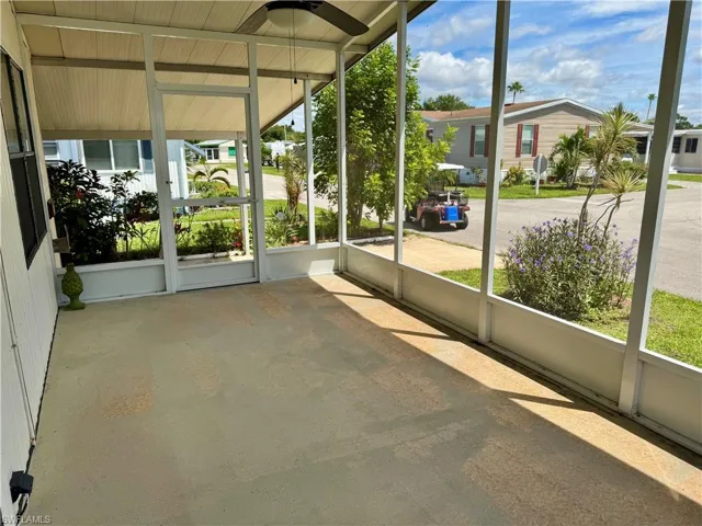 Unfurnished sunroom with a ceiling fan