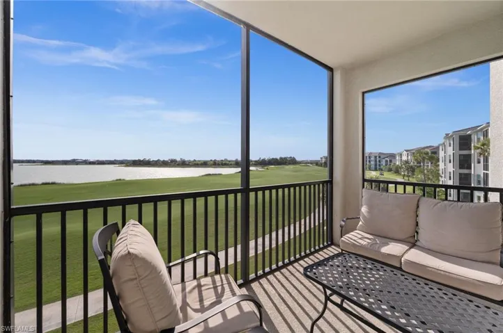 Screened balcony featuring expansive water and golf course scenery