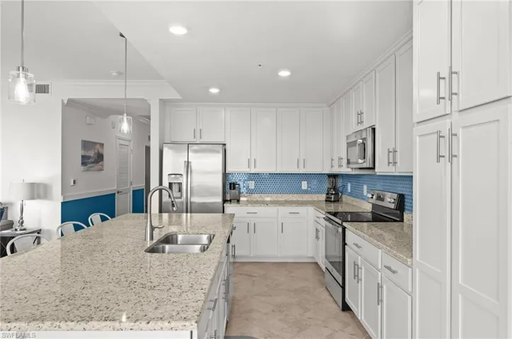 Modern kitchen with white cabinetry and stainless steel appliances