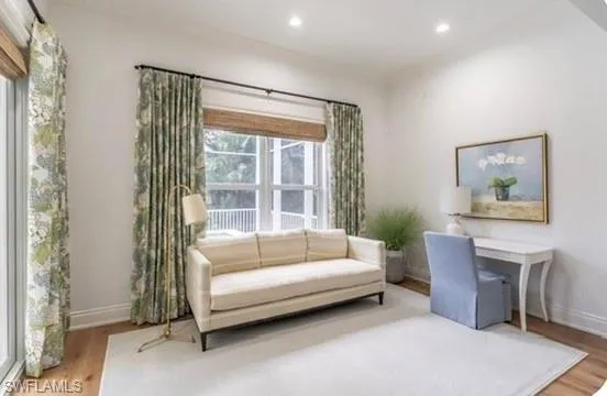 Sitting room with wood finished floors and recessed lighting