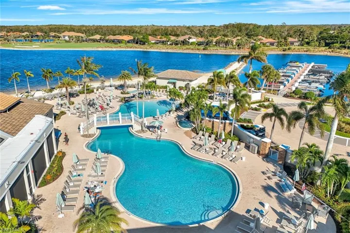 Community pool with a water view and a patio area