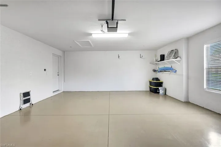 Garage featuring a garage door opener