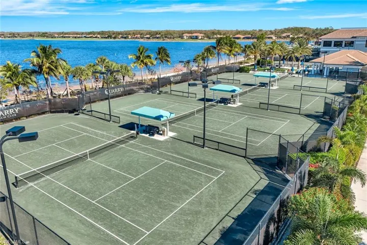 View of tennis court featuring a water view