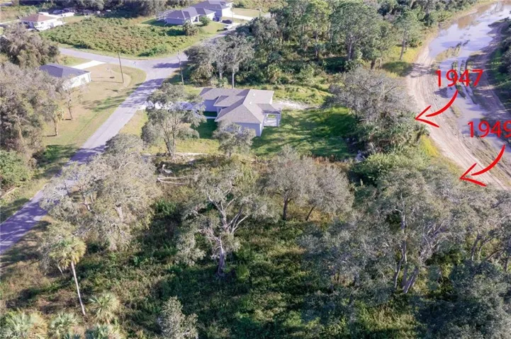 Birds eye view of property with a water view
