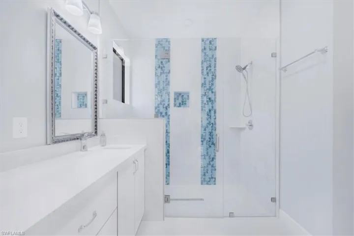 Bathroom with vanity and a stall shower