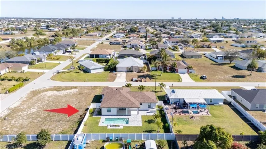 Aerial view of property's location with nearby suburban area