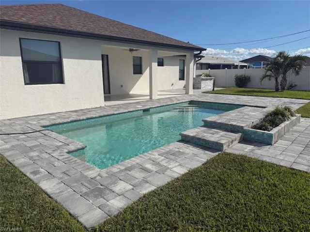 View of pool with a patio area and a fenced backyard