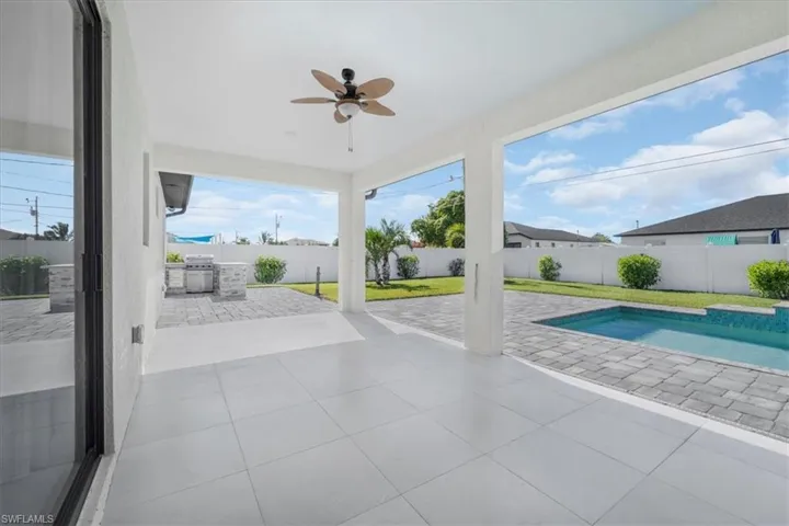 View of pool featuring a patio, a fenced backyard, and a grill