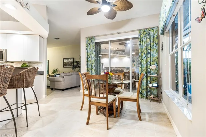 Dining space featuring light tile patterned flooring and ceiling fan