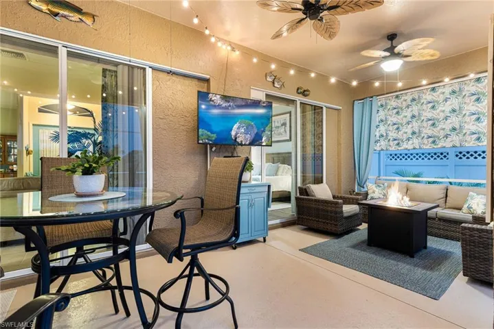View of patio featuring an outdoor living space and ceiling fan