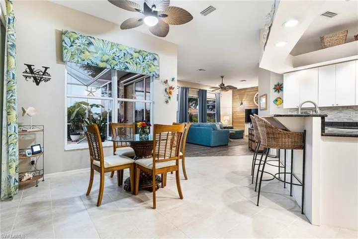Dining area featuring light tile patterned floors and ceiling fan