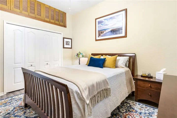 Bedroom with a closet and hardwood / wood-style floors