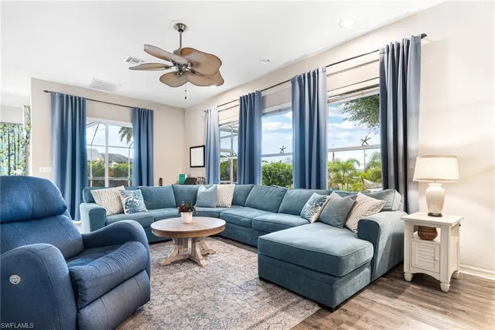 Living room featuring ceiling fan and hardwood / wood-style floors