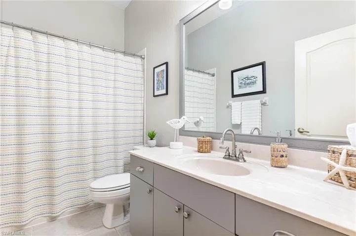 Bathroom with tile patterned floors, toilet, and vanity