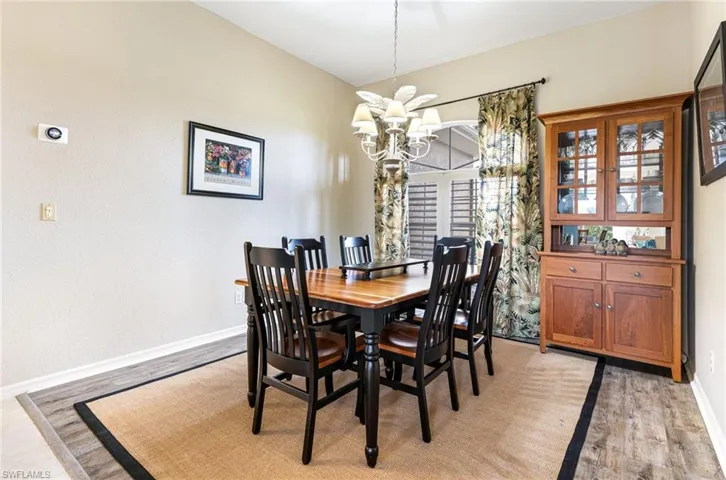 Dining area featuring light hardwood / wood-style flooring and an inviting chandelier