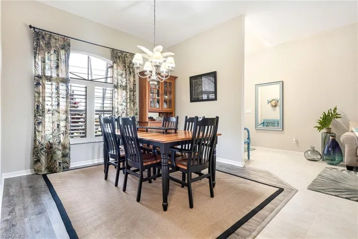 Tiled dining area featuring a chandelier