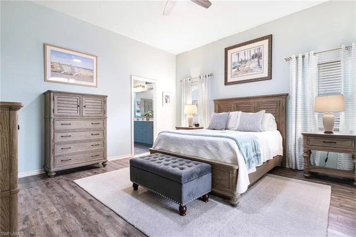 Bedroom featuring connected bathroom, ceiling fan, and hardwood / wood-style floors
