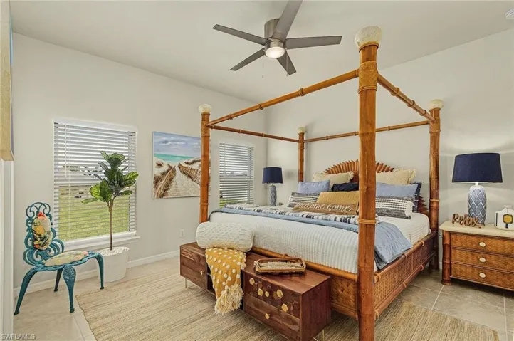 Bedroom featuring light tile patterned floors and ceiling fan