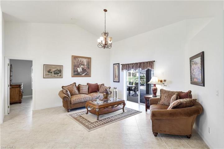 Large living room with sliders to the pool and spa.