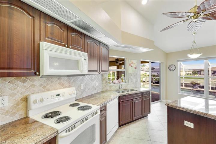 Ample counter space, granite counters, stone backsplash -- NICE!