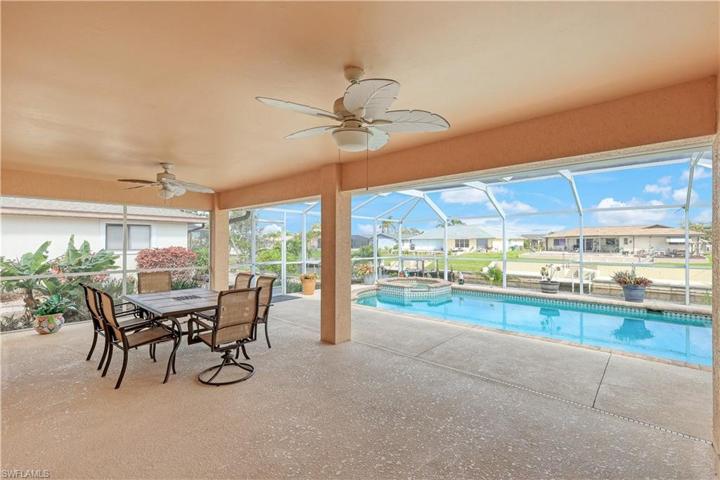 Spacious screened lanai under truss offers a pleasant dining area.