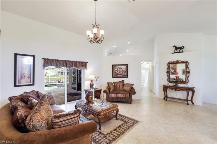 Living Room with view to pool and down the hall to the Kitchen. LOTS of closets and storage space in this immaculate home!