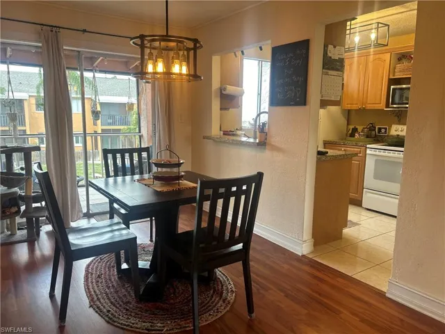 Dining room with a chandelier and light tile flooring
