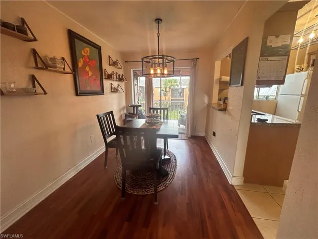 Dining space featuring hardwood / wood-style floors and a chandelier