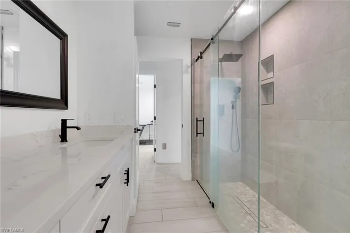 Contemporary bathroom featuring a spacious vanity with a white countertop and undermount sink