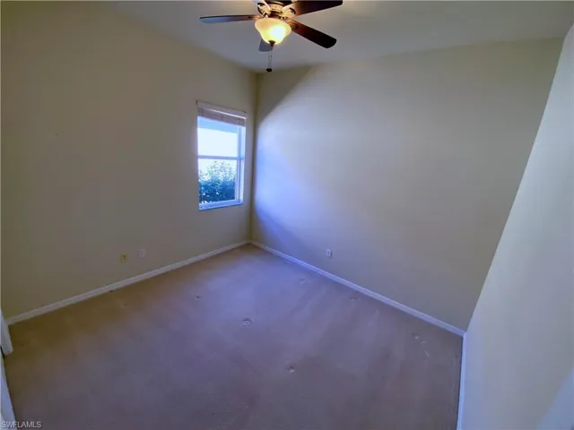 Unfurnished room with carpet floors and a ceiling fan