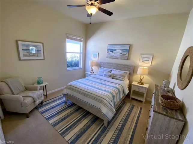 Bedroom with ceiling fan and dark colored carpet