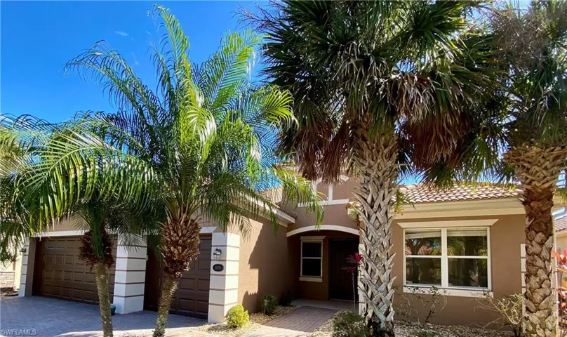 View of front of home featuring a garage, stucco siding, and driveway
