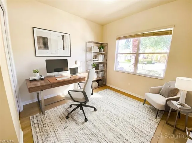 Office area featuring baseboards and light wood-style floors