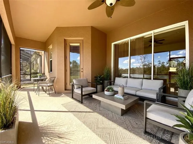 View of patio featuring a ceiling fan and an outdoor living space