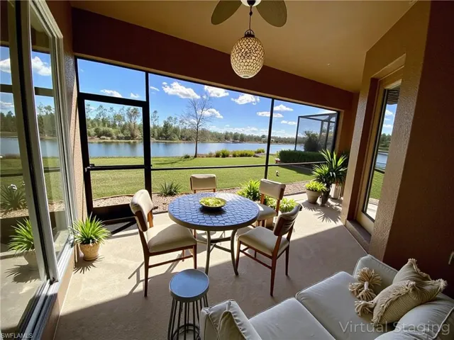 Sunroom featuring a water view, plenty of natural light, and a textured wall