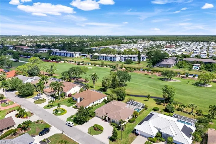 Aerial view of residential area featuring a golf club