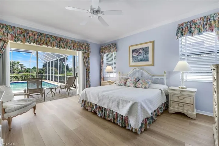 Bedroom with access to exterior, ornamental molding, a sunroom, light wood-style flooring, and ceiling fan