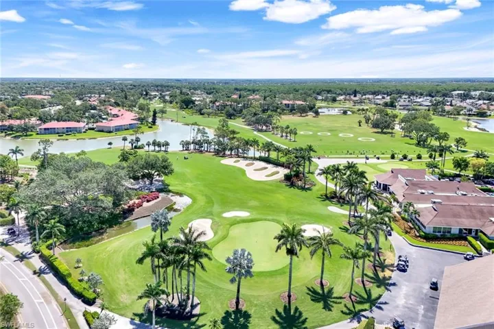 Aerial view of residential area with a large body of water and a local golf course