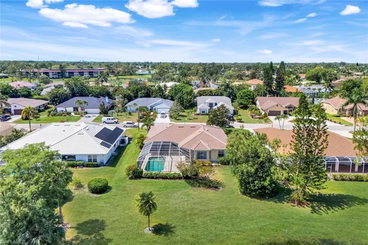 Aerial view of residential area featuring a pool