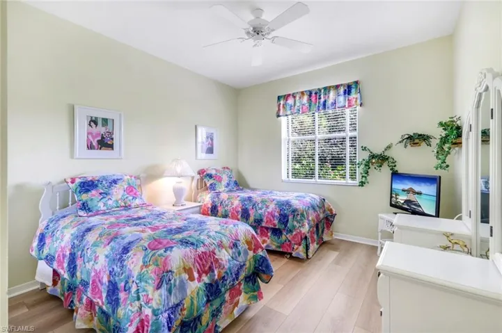 Bedroom with baseboards, light wood-style flooring, and ceiling fan